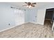 Bedroom with light walls, wood-look floors, and a ceiling fan at 5819 Driftwood Dr, Winter Haven, FL 33884