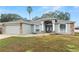 Curb appeal of a single-story home with stone accents and a two-car garage at 5819 Driftwood Dr, Winter Haven, FL 33884