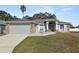 Charming one-story house with a two-car garage and landscaped lawn at 5819 Driftwood Dr, Winter Haven, FL 33884