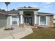 House exterior features a covered entryway and stone accents at 5819 Driftwood Dr, Winter Haven, FL 33884