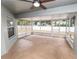 Screened-in porch with concrete flooring and ceiling fan at 5819 Driftwood Dr, Winter Haven, FL 33884