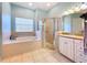 Elegant bathroom featuring a shower, tub, and double vanity at 5825 High Ridge Loop, Lakeland, FL 33812