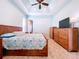 Spacious bedroom with large bed, dresser, and ceiling fan at 5825 High Ridge Loop, Lakeland, FL 33812