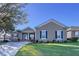 One-story house with a tan exterior, dark shutters, and a well-maintained lawn at 5825 High Ridge Loop, Lakeland, FL 33812