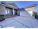 House exterior showcasing a double door entry and a two-car garage at 5825 High Ridge Loop, Lakeland, FL 33812