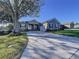 Single-story house with a two-car garage and manicured lawn at 5825 High Ridge Loop, Lakeland, FL 33812