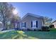 One-story house with tan exterior, dark shutters, and a large driveway at 5825 High Ridge Loop, Lakeland, FL 33812