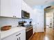 Modern kitchen with white cabinets, stainless steel appliances, and quartz countertops at 5825 High Ridge Loop, Lakeland, FL 33812