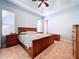 Primary bedroom with a king-size bed, wooden furniture and light blue walls at 5825 High Ridge Loop, Lakeland, FL 33812