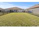 Spacious backyard with a grassy area and a fence at 5876 Great Salt Ct, Lakeland, FL 33805