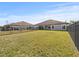 Large backyard with grassy lawn and black metal fence at 5876 Great Salt Ct, Lakeland, FL 33805