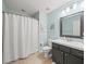 Bathroom with dark vanity, tiled floor, and shower/tub combo at 5876 Great Salt Ct, Lakeland, FL 33805