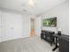 Bedroom with double doors, carpet, and a media cabinet at 5876 Great Salt Ct, Lakeland, FL 33805