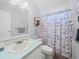 Bathroom with shower/tub combo, vanity, and patterned curtain at 6087 Southern Oaks Se Dr, Winter Haven, FL 33884