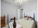 Bedroom with a wooden bed frame and gray walls at 6087 Southern Oaks Se Dr, Winter Haven, FL 33884