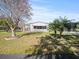 Single-wide manufactured home with carport and landscaped yard at 6087 Southern Oaks Se Dr, Winter Haven, FL 33884