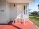 Inviting front entryway with brick steps, white door, and well-maintained landscaping at 6087 Southern Oaks Se Dr, Winter Haven, FL 33884