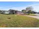 Single-story house with covered patio and yard at 6087 Southern Oaks Se Dr, Winter Haven, FL 33884