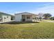 Single-story house with covered patio and yard at 6087 Southern Oaks Se Dr, Winter Haven, FL 33884