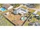 Aerial view of house and backyard, showcasing pool and playset at 6357 Neamathla Dr, Lakeland, FL 33813