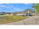 Side view of house showcasing a large yard and driveway at 6357 Neamathla Dr, Lakeland, FL 33813