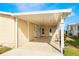 Covered carport with light-colored stone patio at 6823 S Lake Henry Ne Dr, Winter Haven, FL 33881