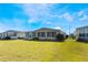 Tan house with screened porch and grassy yard at 6823 S Lake Henry Ne Dr, Winter Haven, FL 33881