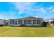 Tan house with screened porch and grassy yard at 6823 S Lake Henry Ne Dr, Winter Haven, FL 33881