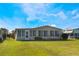 Tan mobile home with a large grassy yard at 6823 S Lake Henry Ne Dr, Winter Haven, FL 33881