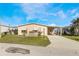 Front view of a tan mobile home with a carport at 6823 S Lake Henry Ne Dr, Winter Haven, FL 33881