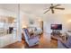 Bright living room with hardwood floors, comfy furniture and kitchen peek at 6823 S Lake Henry Ne Dr, Winter Haven, FL 33881