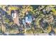 An aerial view showing a house, detached structure, and large lot with trees at 7030 Klein Rd, Lakeland, FL 33813