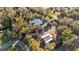 Aerial view of a house and detached barn on a wooded lot at 7030 Klein Rd, Lakeland, FL 33813