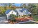 White farmhouse with metal roof, landscaping, and long driveway at 7030 Klein Rd, Lakeland, FL 33813