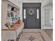 Bright entryway with a charming hutch, decorative tile, and a dark gray door at 7030 Klein Rd, Lakeland, FL 33813