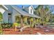 House exterior showcasing a front porch with hanging plants and a walkway at 7030 Klein Rd, Lakeland, FL 33813