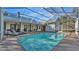 Relaxing pool area with sun loungers and a screened enclosure for outdoor enjoyment at 7030 Klein Rd, Lakeland, FL 33813