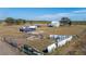 Aerial view of home, outbuildings, and fenced areas at 7275 Lake Hendry Rd, Fort Meade, FL 33841