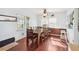 Simple dining area with wooden table and chairs, hardwood floors at 7275 Lake Hendry Rd, Fort Meade, FL 33841