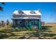 Country home with metal roof, porch swing, and expansive yard at 7275 Lake Hendry Rd, Fort Meade, FL 33841