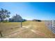 Entrance to property with gate and open field at 7275 Lake Hendry Rd, Fort Meade, FL 33841