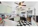 Retro kitchen with light green cabinets and black and white checkered floors at 7275 Lake Hendry Rd, Fort Meade, FL 33841