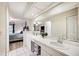 Bathroom with double vanity, view of bedroom, and tile flooring at 781 Sagewood Dr, Lakeland, FL 33813