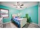 Light teal bedroom with a twin bed and ceiling fan at 781 Sagewood Dr, Lakeland, FL 33813