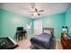 Light teal bedroom with a twin bed, desk, and ceiling fan at 781 Sagewood Dr, Lakeland, FL 33813