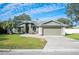 House exterior view, green color, landscaping, and a two-car garage at 781 Sagewood Dr, Lakeland, FL 33813