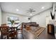 Bright living room with L-shaped sectional sofa, ceiling fan, and dark wood floors at 781 Sagewood Dr, Lakeland, FL 33813