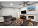 Comfortable living room featuring a fireplace, large TV, and area rug at 781 Sagewood Dr, Lakeland, FL 33813