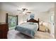 Main bedroom with king-size bed, ceiling fan, and large windows at 781 Sagewood Dr, Lakeland, FL 33813