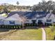 House with gray roof, brick facade and manicured lawn at 825 E Mann Rd, Bartow, FL 33830